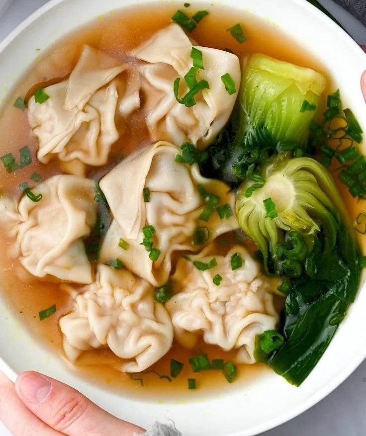 Bowl of Chicken Wonton Soup with tender chicken and handcrafted wontons in broth.