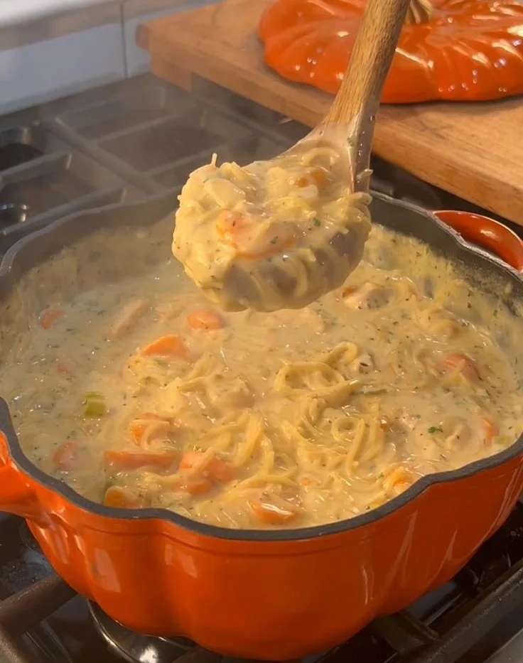 Creamy chicken and vegetable soup in a bowl garnished with herbs