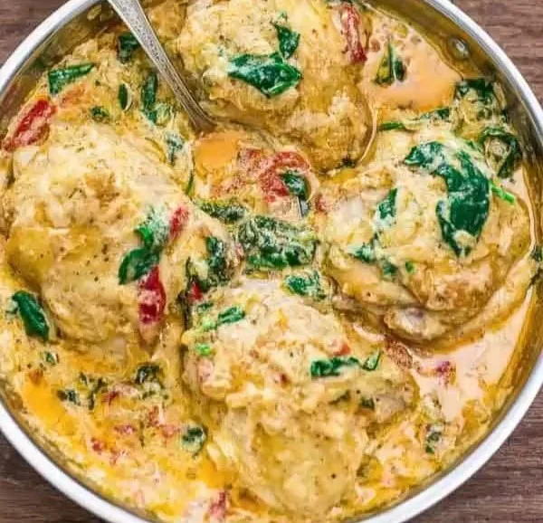 Delicious creamy chicken thighs garnished with herbs