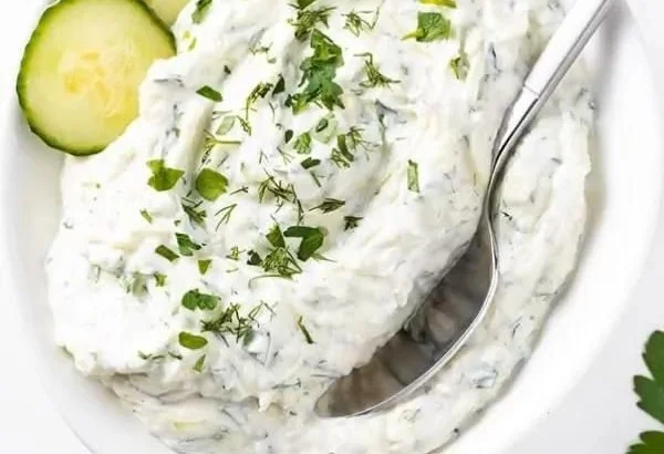 Bowl of easy Greek tzatziki sauce with fresh ingredients
