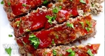 Gluten-free low-carb instant pot meatloaf served on a plate with herbs