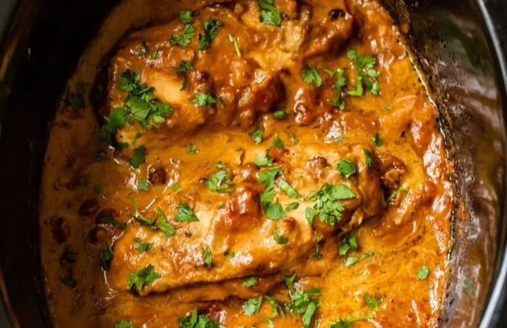 Delicious Slow Cooker Peanut Chicken garnished with herbs
